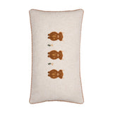 Rectangular linen cushion in oatmeal with three tufted rust-brown highland cows in a vertical row, embroidered grass tufts between them, and gingham piped edging on a plain white background.