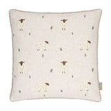 Rambshe Velvet Linen Cushion in Natural, a square cushion with embroidered sheep and tufted grass motifs on a flecked linen-blend ground, shown on a plain white background.