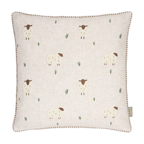 Rambshe Velvet Linen Cushion in Natural, a square cushion with embroidered sheep and tufted grass motifs on a flecked linen-blend ground, shown on a plain white background.