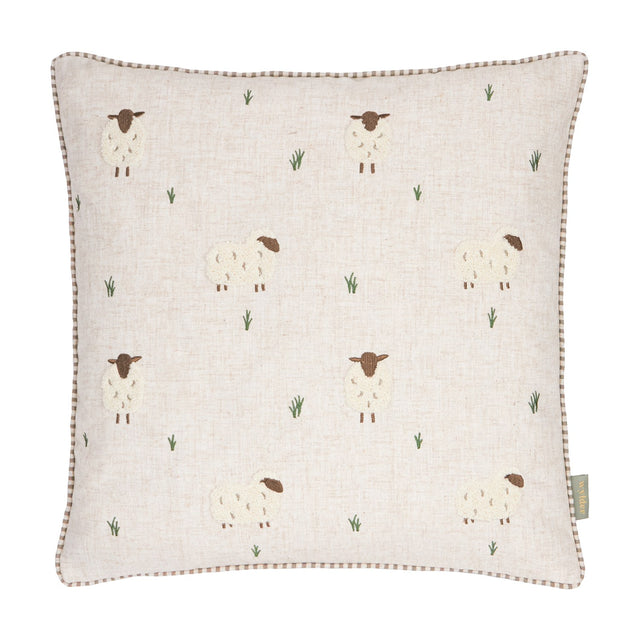 Rambshe Velvet Linen Cushion in Natural, a square cushion with embroidered sheep and tufted grass motifs on a flecked linen-blend ground, shown on a plain white background.