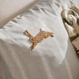 Ramble Cotton Animal Duvet Cover Set in Sage, close-up of a tufted caramel-brown hare with white tail on a striped cotton ground, styled with a folded green-check throw.