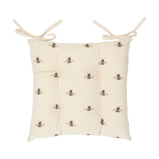 Square tufted seat pad in natural cotton with a bumble bee print, buttoned centre, and two fabric ties at the top corners, shown on a plain white background.
