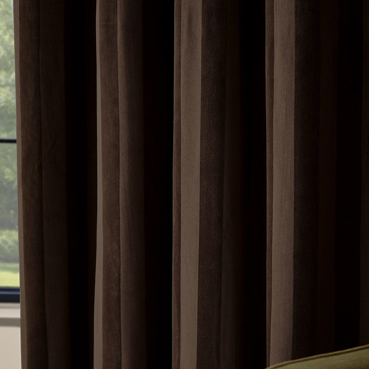 Regency Stripe Velvet Fully Lined Eyelet Curtains in chocolate brown, shown close-up with vertical pile stripes and eyelet heading, hung by a window.