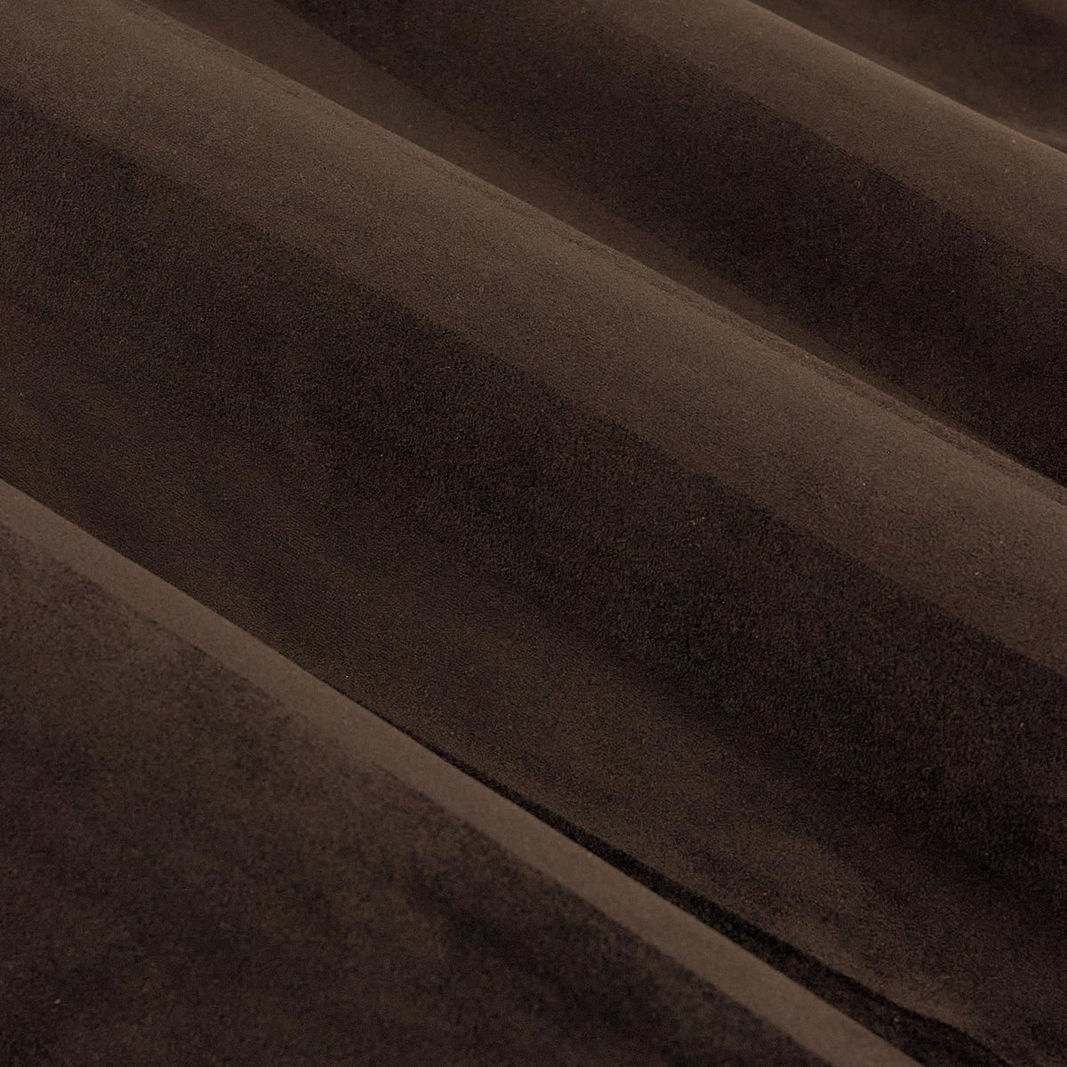 Close-up of Regency Stripe eyelet curtain fabric in chocolate brown velvet, showing vertical pile stripes creating subtle light and shade variation.