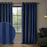 Regency Stripe Velvet Fully Lined Eyelet Curtains in Midnight navy blue, shown on a copper rod in a living room with a tonal stripe swatch inset and a green armchair nearby.