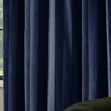 Close-up of Regency Stripe velvet eyelet curtains in Midnight navy, showing soft-pile fabric with subtle vertical stripes and deep tonal folds, hung by a window.
