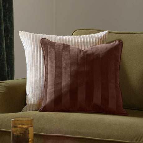 Regency Stripe Jacquard Velvet Cushion in chocolate brown with tonal striped pile, shown on an olive green sofa beside a cream ribbed cushion.