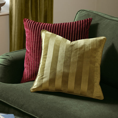 Regency Stripe Jacquard Velvet Cushion in olive green with woven vertical stripe pile, shown on a green sofa beside a red striped cushion.