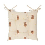 Rhighco Linen Cotton Seat Pad in Natural, a tufted tie-on cushion with highland cow and yellow flower prints on cream slub fabric, shown on a white background.