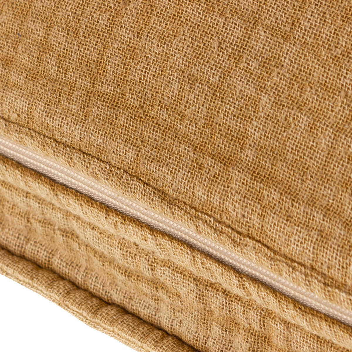 Close-up of the Ribble Reversible Cotton Cushion in honey, showing the ribbed cotton weave and a hidden zip closure along the seam edge.