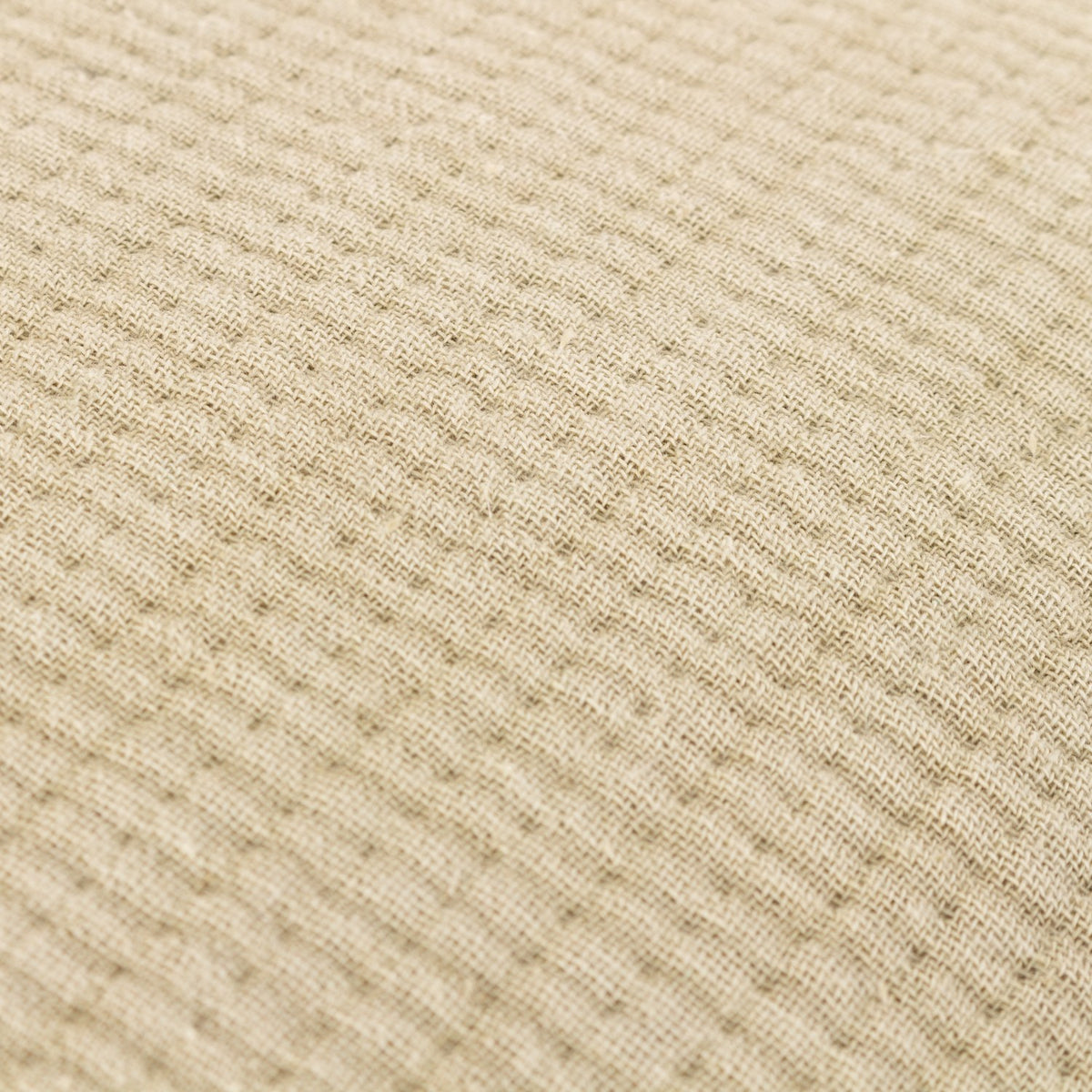 Close-up of the Ribble Reversible Cotton Cushion in natural, showing its textured, ribbed woven cotton fabric with a fine grained surface.