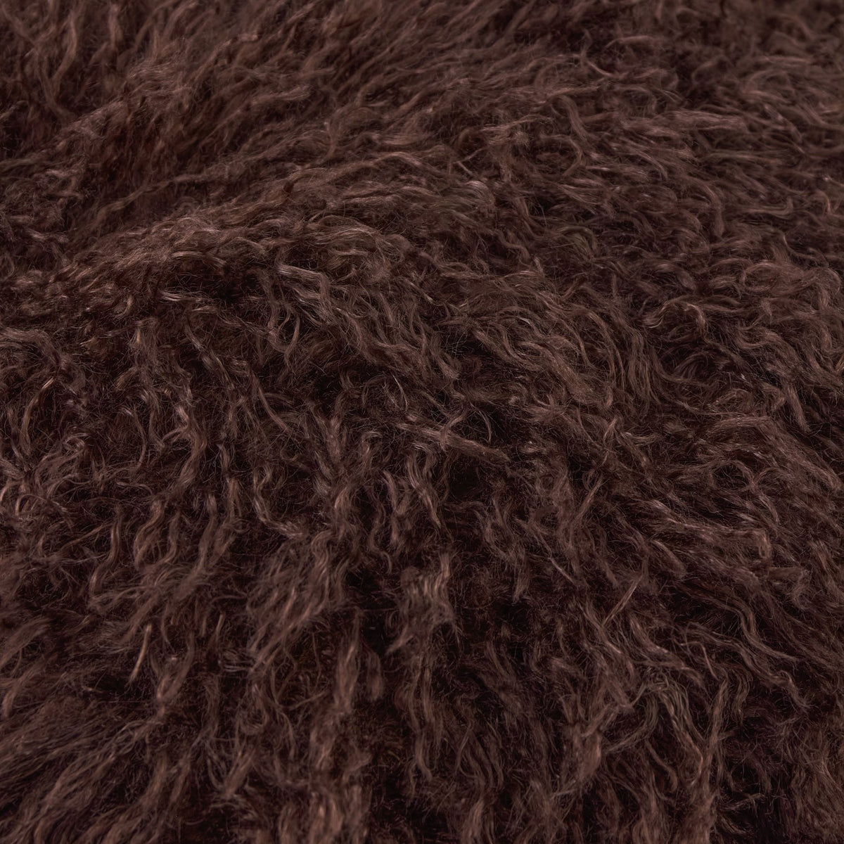 Close-up of the Rowan Velvet Faux Fur Cushion in chocolate brown, showing the long shaggy faux fur pile texture on the front face.