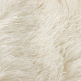 Close-up of the Rowan Faux Fur Plain Velvet Cushion's shaggy ecru faux fur front, showing long, loose pile in a warm off-white tone.