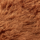 Close-up of the Rowan Faux Fur Plain Velvet Throw in ginger, showing long-pile shaggy faux Mongolian fur strands in a warm rust tone.
