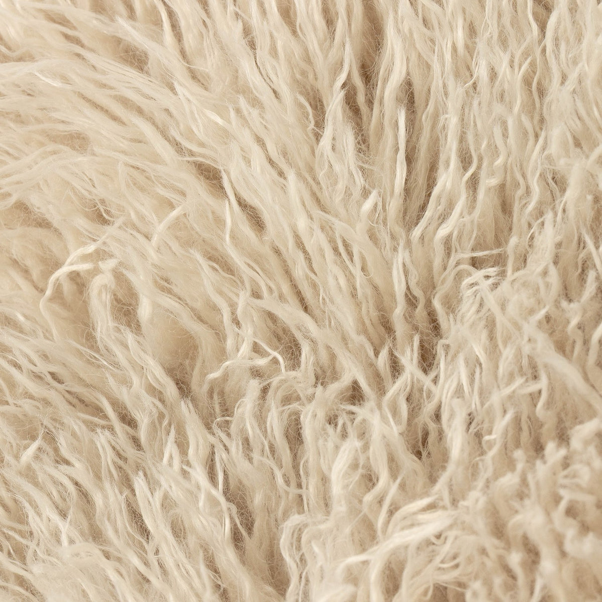 Close-up of the Rowan Faux Fur Plain Velvet Throw in natural beige, showing the long, shaggy Mongolian-style faux fur pile texture on the face side.