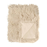 Rowan Faux Fur Plain Velvet Throw in natural beige, shaggy Mongolian-style fur front with folded corner revealing matching smooth velvet reverse, shown on a plain white background.