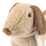 Close-up of the Samson Sand Filled Faux Fur Door Stop, a dog-shaped design in sandy beige with tan drooping ears, a white neck scarf, and stitched muzzle, on a white background.