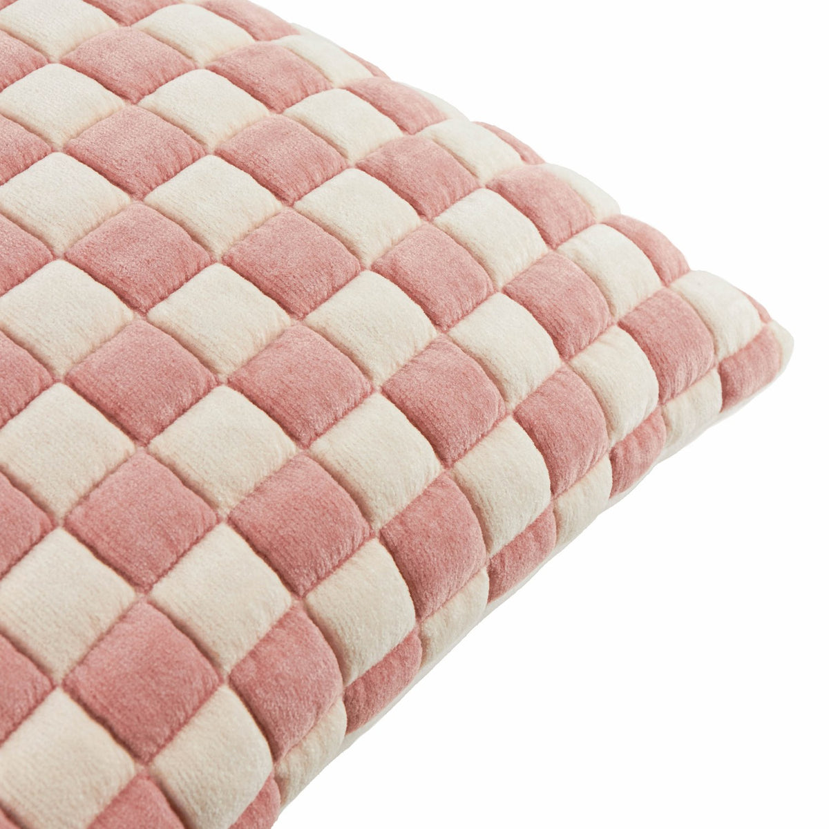 Close-up of the Softie Check Polyester Cushion in pink, showing a quilted checkerboard pattern of raised pink and cream velvet blocks on a plain white background.