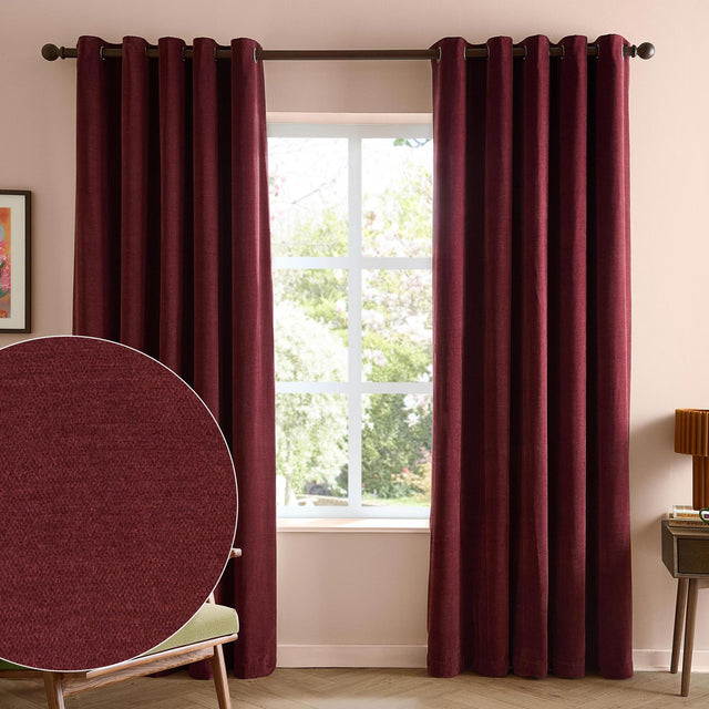 Soft chenille eyelet curtains in deep beetroot red hanging on a pole in a living room, with a fabric texture close-up inset showing the matt polyester weave.