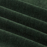 Close-up of soft chenille fabric in bottle green, showing pile yarn texture and eyelet curtain folds with a matt, velvety surface.