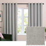 Silver grey chenille eyelet curtains hanging from a black rod in a living room window, shown with a fabric swatch of the plush woven texture.