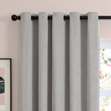 Silver grey eyelet curtains in soft chenille fabric, shown hanging on a black rod with visible grommets in a room with pink walls.