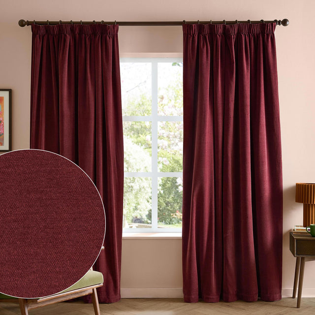 Beetroot red pencil pleat chenille curtains hanging on a rod either side of a window in a pink-walled room, with a fabric texture close-up inset.
