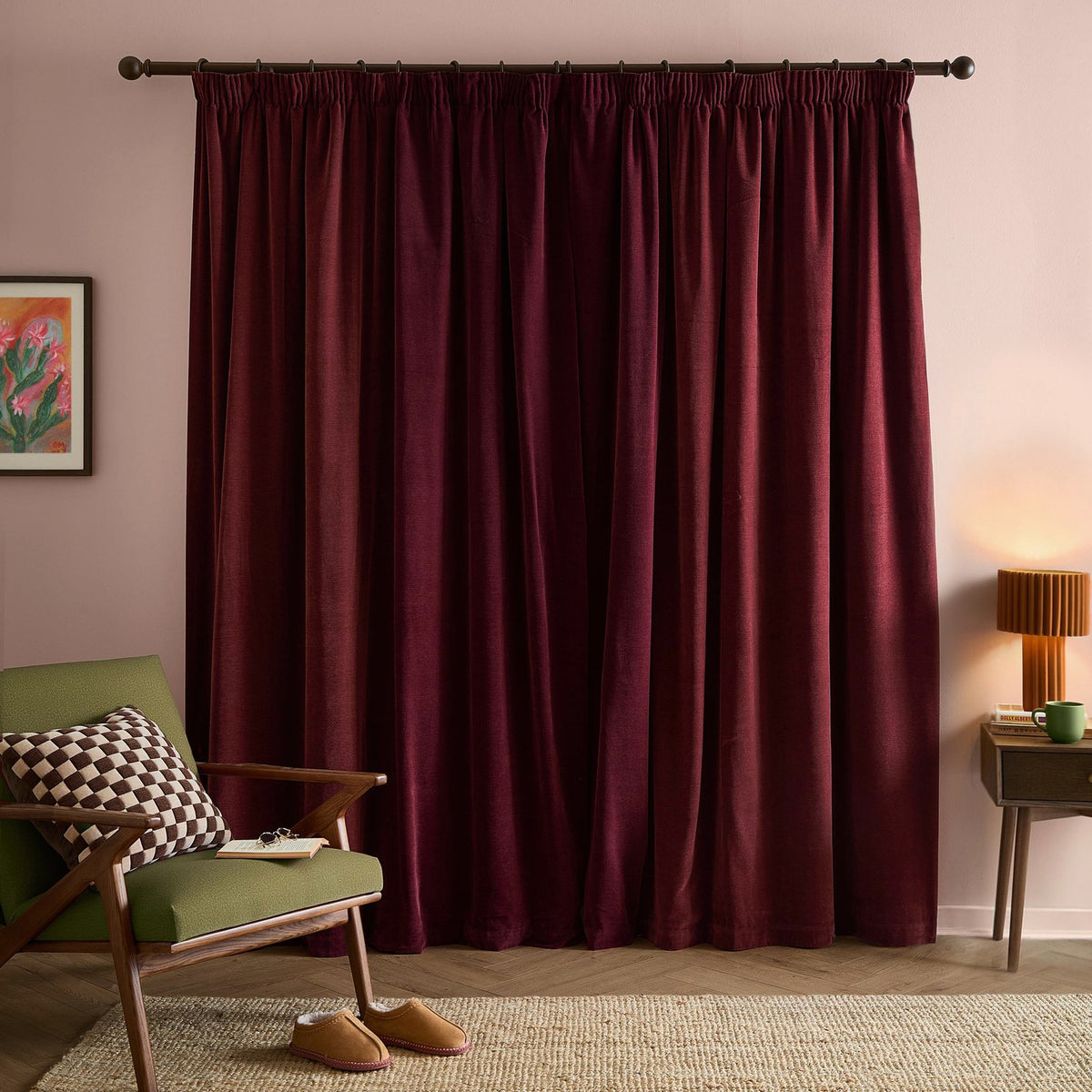 Beetroot red chenille pencil pleat curtains with pencil pleat heading, shown floor-length on a dark rod in a pink-walled living room setting.