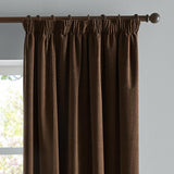 Chocolate brown chenille pencil pleat curtains with pencil-pleat heading hung on a dark metal pole, shown against a light grey wall beside a window.