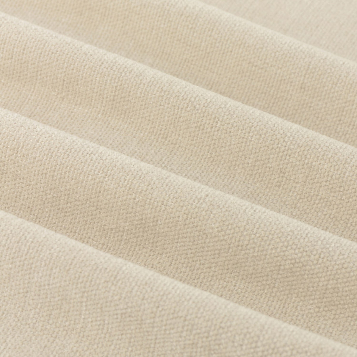 Close-up of soft chenille pencil pleat curtain fabric in ecru, showing matt polyester texture with soft folds and even drape.
