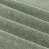 Close-up of soft green chenille fabric with pencil pleat folds, showing a matt, textured polyester weave from the Pencil Pleat Curtains range.