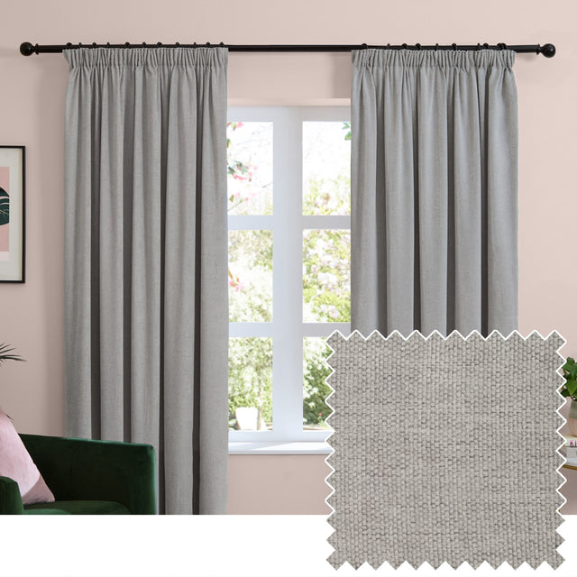 Silver-grey chenille pencil pleat curtains with pencil pleat heading on a black pole, shown in a living room beside a window, with a fabric swatch inset.