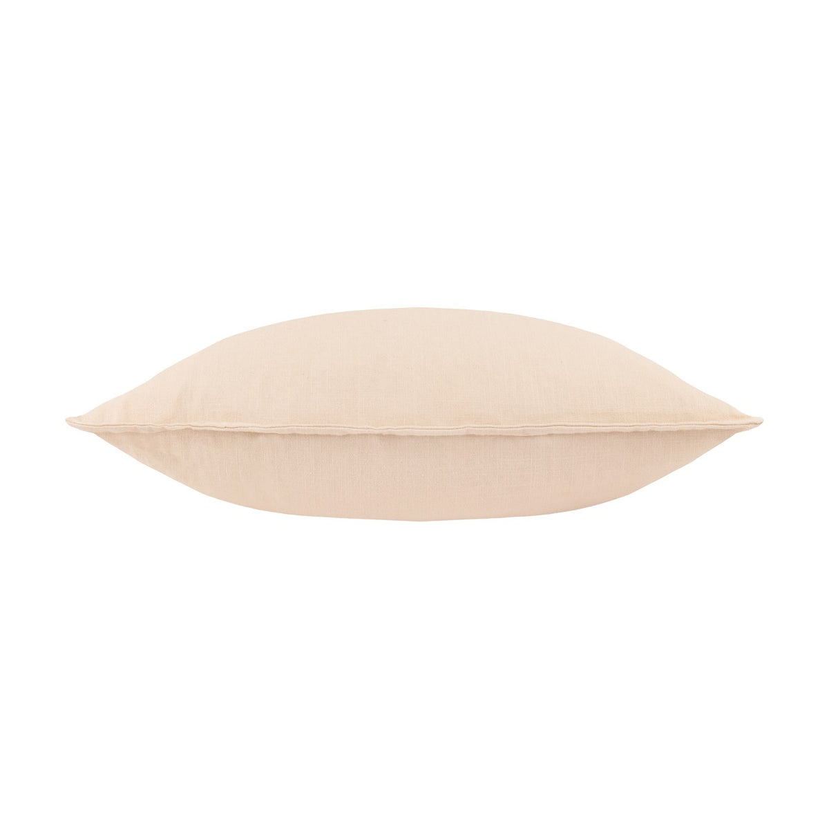 Slub Cotton Plain Linen Cushion in cream with a faint pinkish undertone, shown side-on to reveal its plump shape and piped edge seam against a white background.