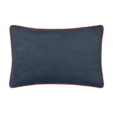 Seaweed Floral Velvet Cushion in Indigo, reverse side shown in plain indigo velvet with red piping trim, rectangular bolster shape on a white background.
