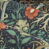 Close-up of Seaweed pencil pleat curtain fabric in indigo velvet, showing coral flowers, sand-toned leaves and scrolling green stems on a dark ground.