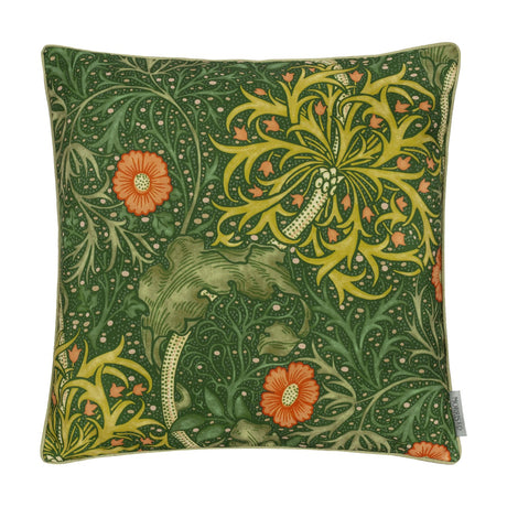 Square polyester cushion in Morris & Co.'s Seaweed Floral design, forest green ground with sage and gold foliage and coral-orange daisy blooms, shown on a plain background.