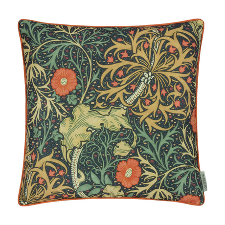 Square Seaweed Floral polyester cushion with indigo ground, orange daisy flowers and gold foliage, finished with contrasting orange piping, on a plain white background.