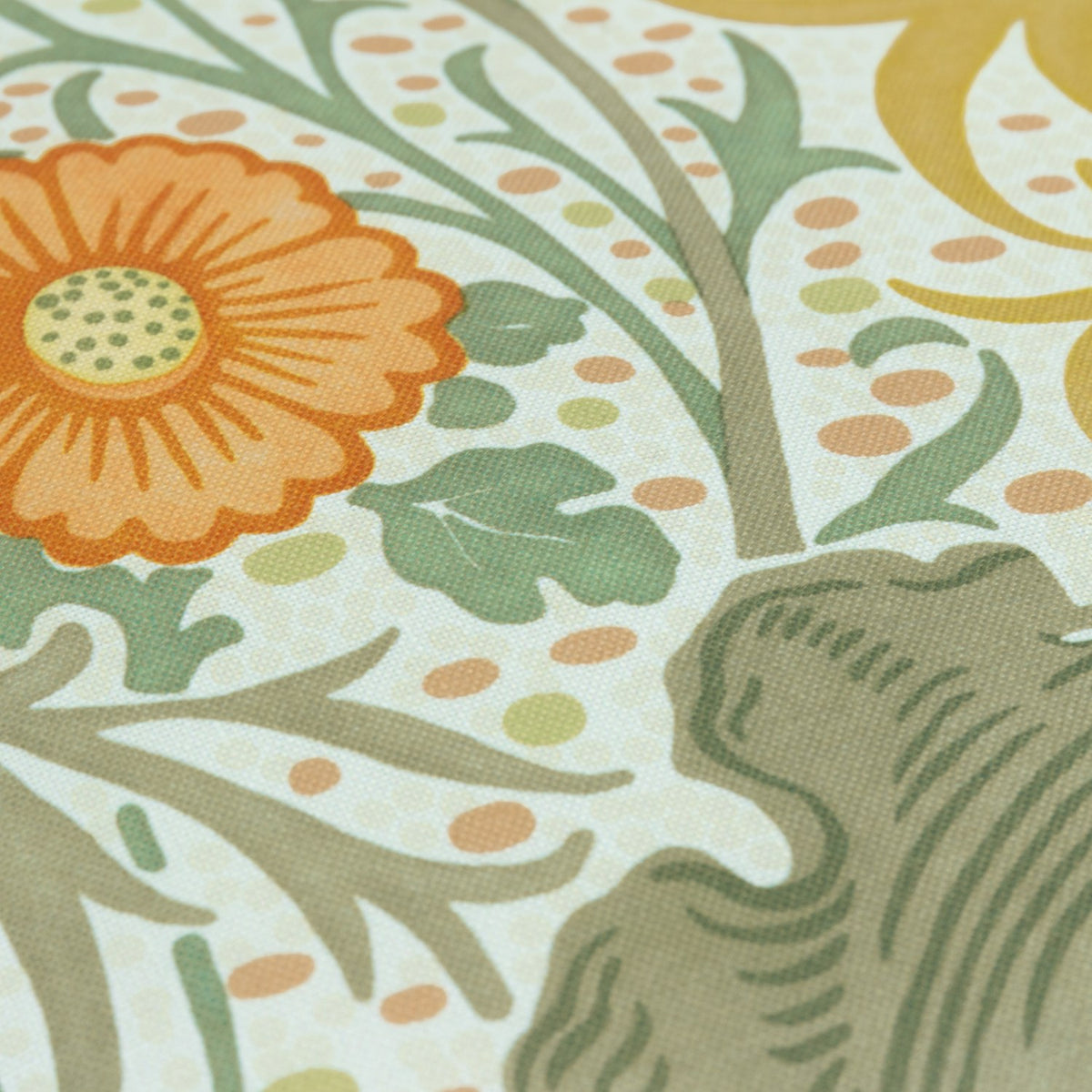 Close-up of the Seaweed Floral polyester cushion in Stone/Sunflower, showing a cream ground with sage-green foliage, an orange flowerhead and gold botanical detailing.