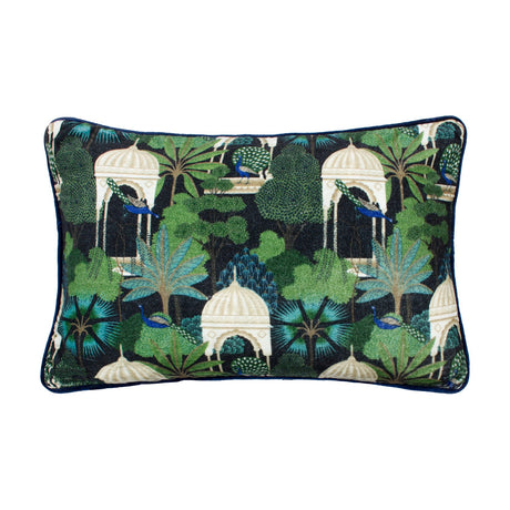 Rectangular cotton velvet cushion in Midnight, featuring a printed tropical garden scene of peacocks, palms and pale domed pavilions in green and blue on black, shown on a white background.