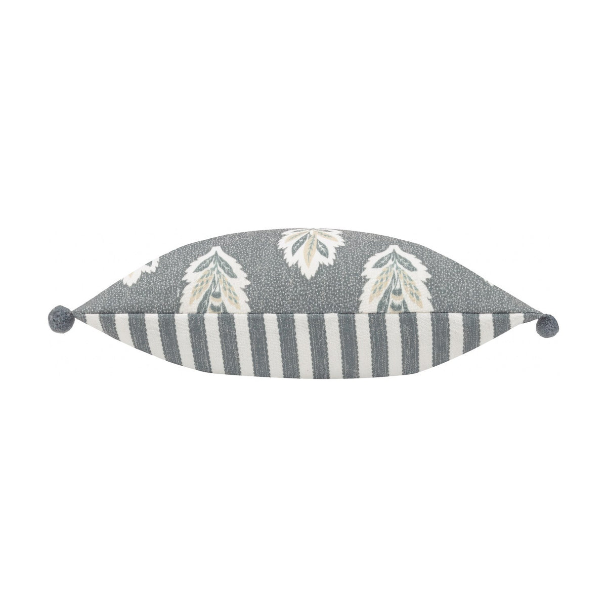 Sessile Leaf Reversible Cotton Cushion in Delph Blue, shown side-on with cream leaf print on one edge and blue-grey stripe on the other, finished with pom-pom corners on a white background.