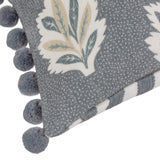 Sessile Leaf Reversible Cotton Cushion in Delph Blue, corner detail showing printed leaf motif, reverse candy stripe, and chunky blue pom-pom trim on white background.