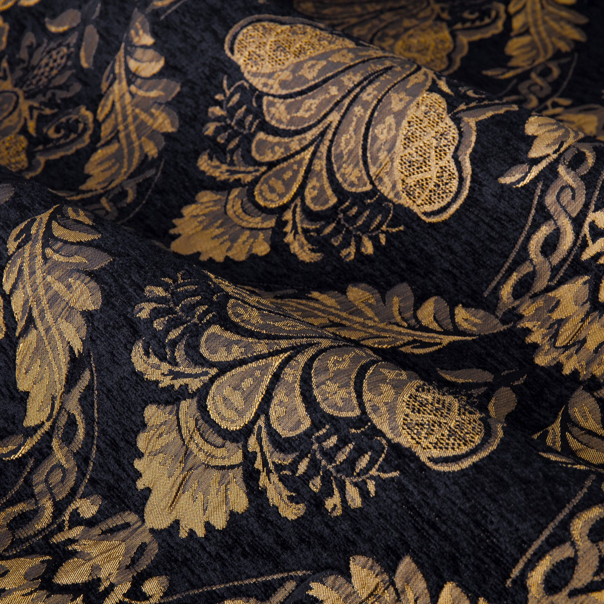 Close-up of Shiraz Jacquard Chenille Pencil Pleat Curtains in black, showing a woven gold floral damask pattern with scalloped and scroll motifs on draped fabric.
