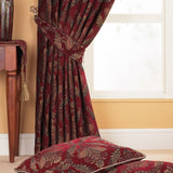 Pencil pleat curtain in burgundy jacquard chenille with a gold and green floral damask pattern, shown tied back beside a window, with matching cushions in the foreground.