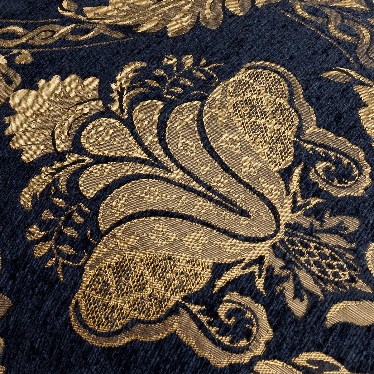 Close-up of the Shiraz Jacquard Chenille Cushion in black, showing a woven gold floral damask pattern with raised, textured detailing on a chenille-style ground.