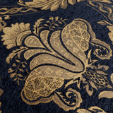 Close-up of the Shiraz Jacquard Chenille Cushion in black, showing a woven gold floral damask pattern with raised, textured detailing on a chenille-style ground.