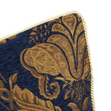 Close-up of the Shiraz Jacquard Chenille Cushion in navy, showing a gold and bronze floral damask pattern with a twisted gold cord trim, on a white background.