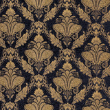 Shiraz Jacquard Chenille Throw in black, woven fabric with a repeating gold floral damask pattern, shown as a close-up of the design.