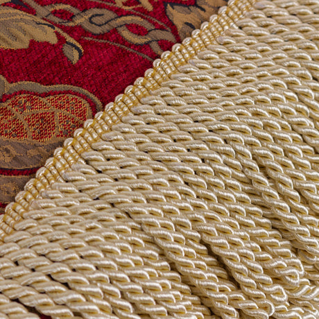 Close-up of the Shiraz Jacquard Chenille Throw in burgundy, showing gold floral damask chenille fabric edged with a twisted gold fringe.