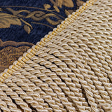 Close-up of the Shiraz Polyester Throw in navy, showing gold damask jacquard weave with a bullion fringe trim along one edge.