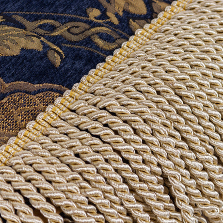 Close-up of the Shiraz Polyester Throw in navy, showing gold damask jacquard weave with a bullion fringe trim along one edge.